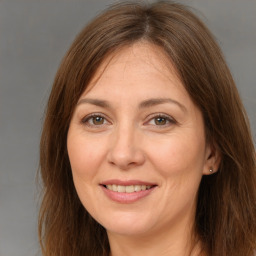 Joyful white adult female with long  brown hair and brown eyes