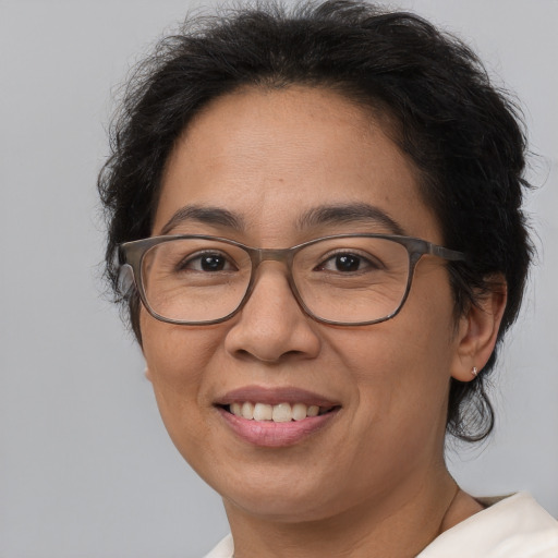 Joyful white adult female with medium  brown hair and brown eyes