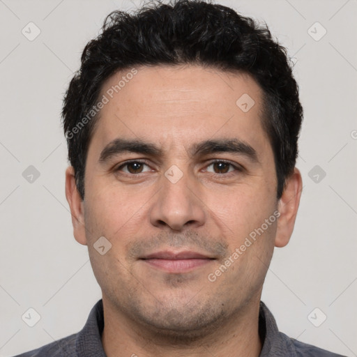 Joyful white young-adult male with short  black hair and brown eyes