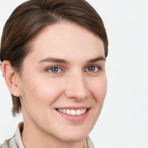 Joyful white young-adult female with short  brown hair and grey eyes