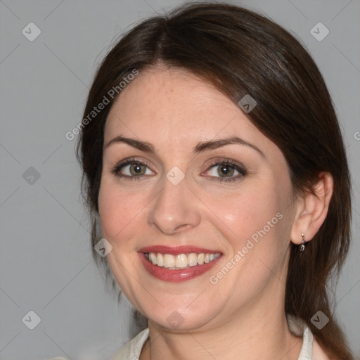 Joyful white adult female with medium  brown hair and brown eyes