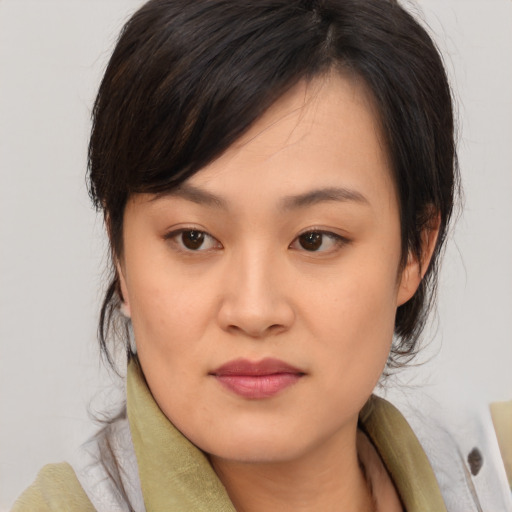 Joyful asian young-adult female with medium  brown hair and brown eyes