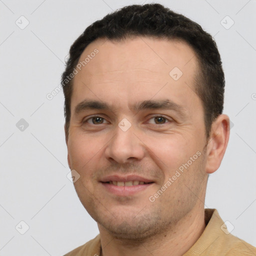 Joyful white young-adult male with short  black hair and brown eyes