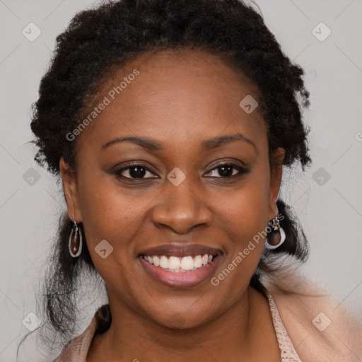 Joyful black young-adult female with long  brown hair and brown eyes