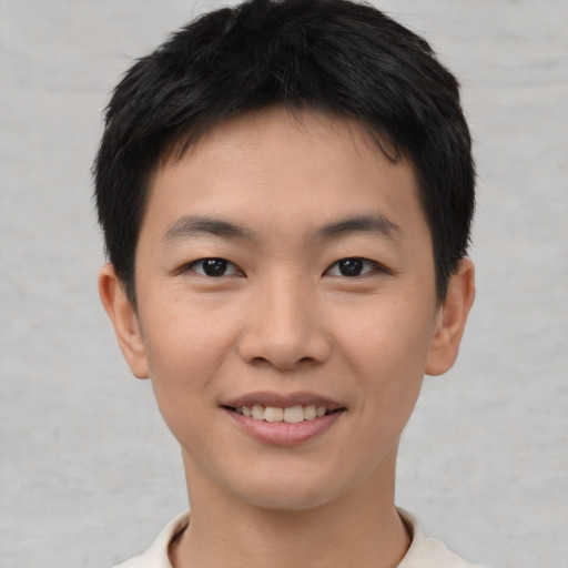 Joyful asian young-adult male with short  brown hair and brown eyes