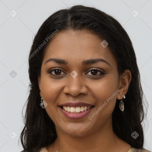 Joyful black young-adult female with long  brown hair and brown eyes