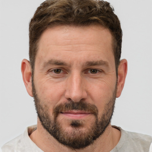 Joyful white adult male with short  brown hair and brown eyes