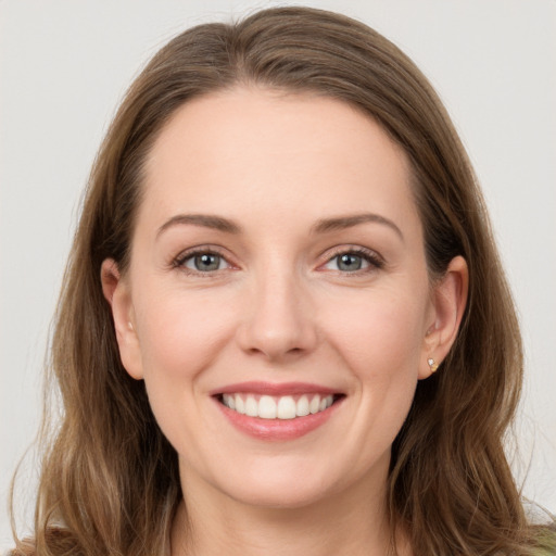 Joyful white young-adult female with long  brown hair and grey eyes