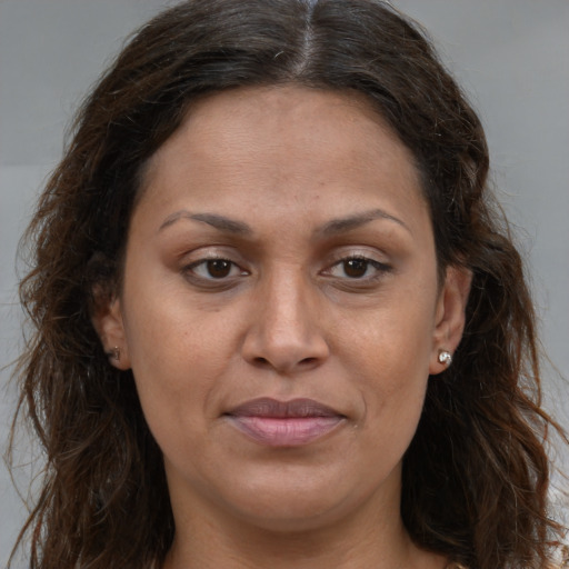 Joyful white adult female with long  brown hair and brown eyes