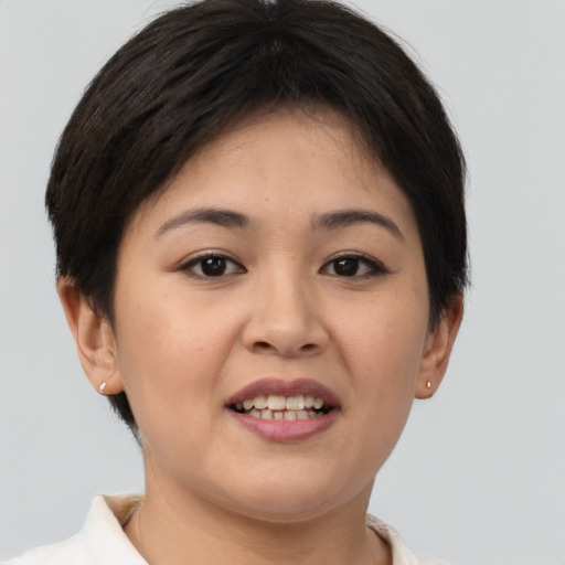 Joyful white young-adult female with short  brown hair and brown eyes