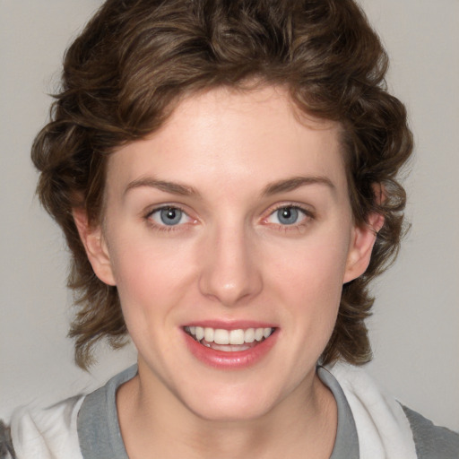 Joyful white young-adult female with medium  brown hair and blue eyes