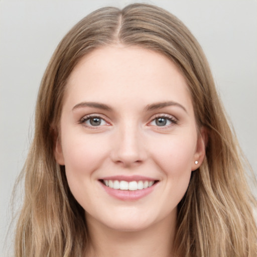 Joyful white young-adult female with long  brown hair and grey eyes