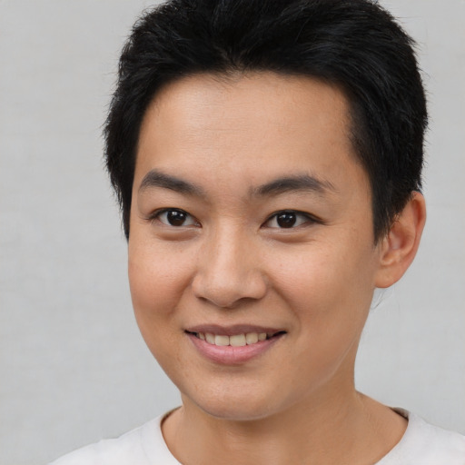 Joyful asian young-adult male with short  brown hair and brown eyes