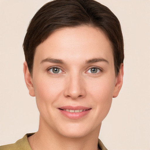 Joyful white young-adult female with short  brown hair and grey eyes