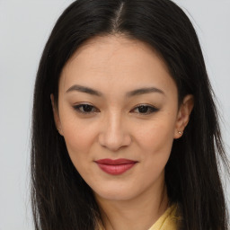 Joyful asian young-adult female with long  brown hair and brown eyes