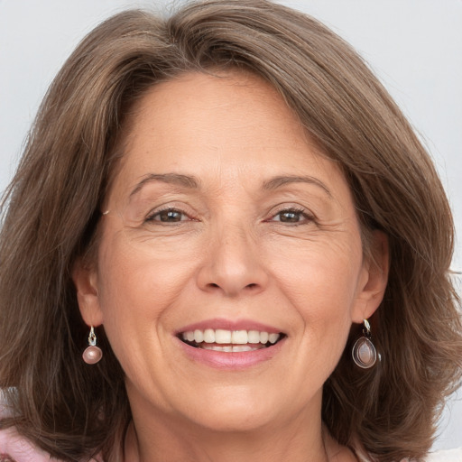 Joyful white adult female with long  brown hair and grey eyes