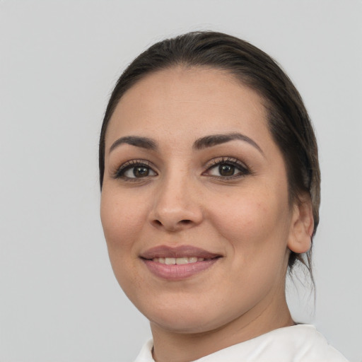 Joyful white young-adult female with medium  brown hair and brown eyes