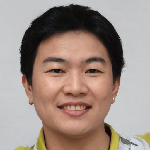 Joyful asian young-adult male with short  black hair and brown eyes