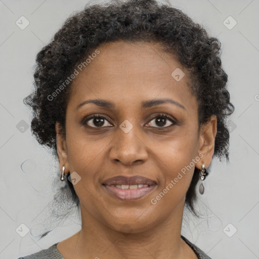 Joyful black adult female with medium  brown hair and brown eyes