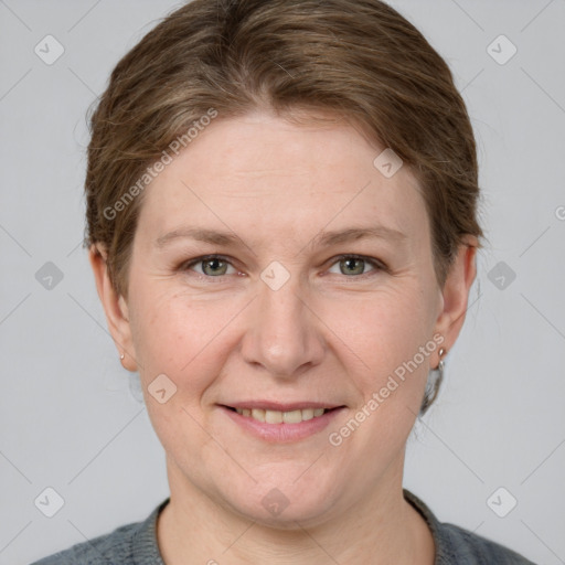 Joyful white adult female with short  brown hair and grey eyes