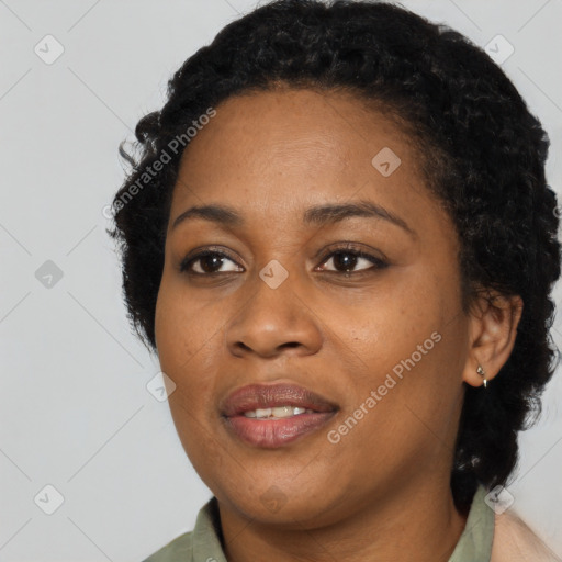 Joyful black young-adult female with long  black hair and brown eyes