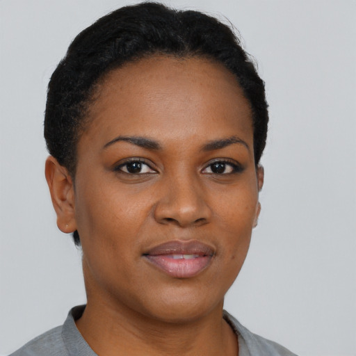 Joyful black young-adult female with short  brown hair and brown eyes