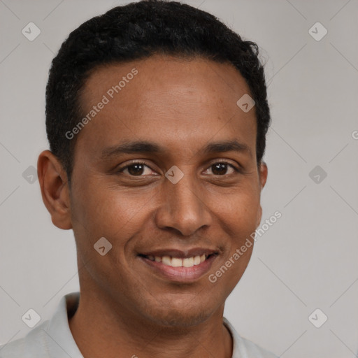 Joyful latino young-adult male with short  brown hair and brown eyes
