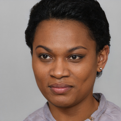 Joyful black young-adult female with short  black hair and brown eyes