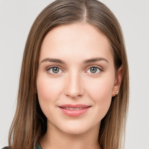 Joyful white young-adult female with long  brown hair and green eyes