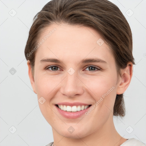 Joyful white young-adult female with short  brown hair and grey eyes