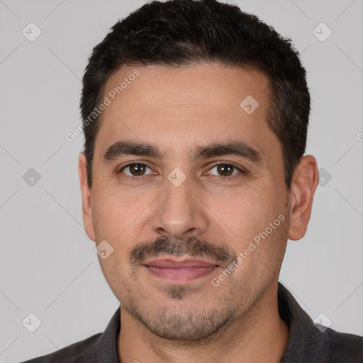 Joyful white adult male with short  black hair and brown eyes