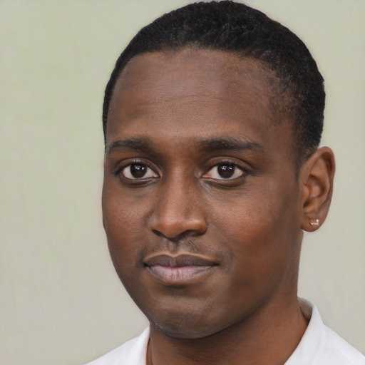 Joyful black young-adult male with short  black hair and brown eyes