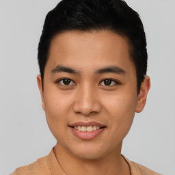 Joyful asian young-adult male with short  brown hair and brown eyes