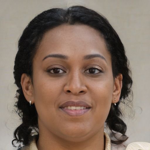 Joyful black young-adult female with medium  brown hair and brown eyes