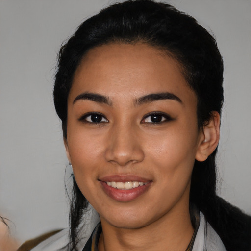 Joyful latino young-adult female with medium  black hair and brown eyes