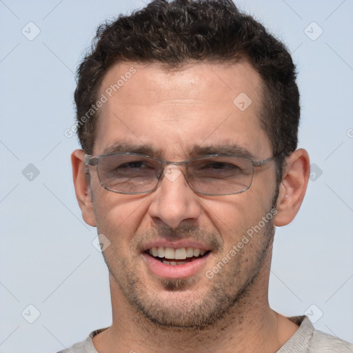 Joyful white adult male with short  brown hair and brown eyes