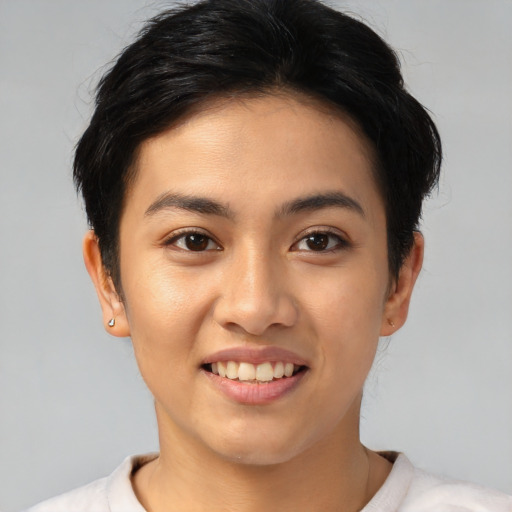 Joyful asian young-adult female with short  brown hair and brown eyes
