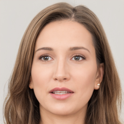 Joyful white young-adult female with long  brown hair and brown eyes