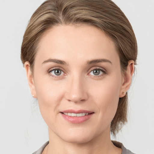 Joyful white young-adult female with medium  brown hair and grey eyes