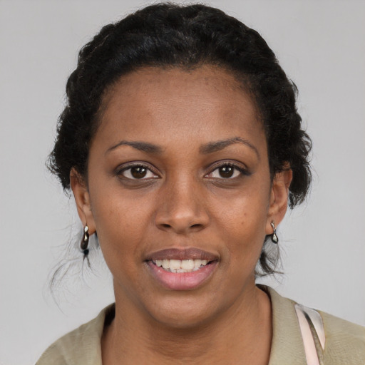 Joyful black young-adult female with short  brown hair and brown eyes