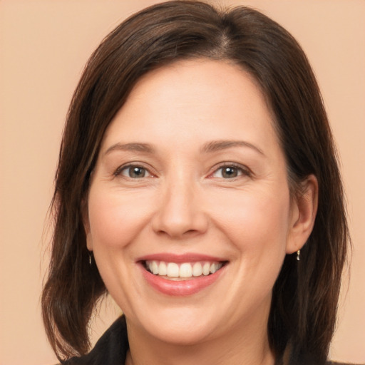 Joyful white adult female with medium  brown hair and brown eyes