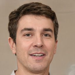 Joyful white adult male with short  brown hair and brown eyes