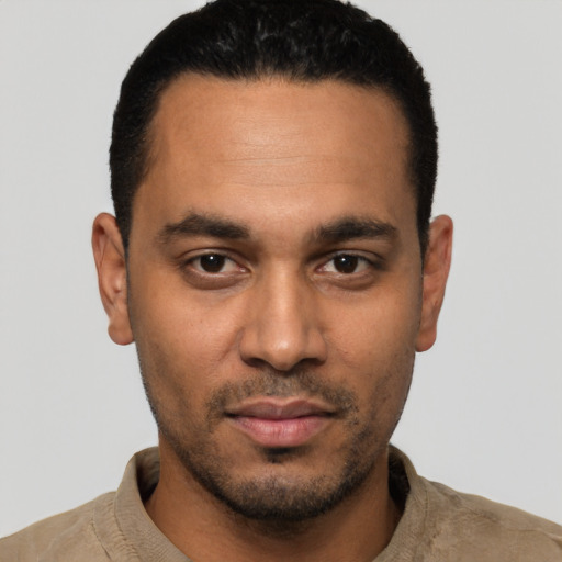 Joyful latino young-adult male with short  black hair and brown eyes