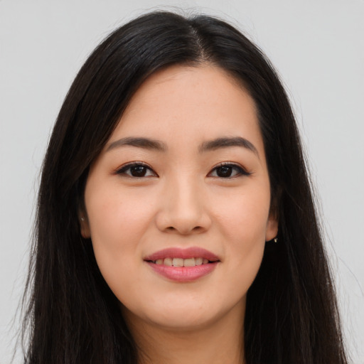 Joyful asian young-adult female with long  brown hair and brown eyes