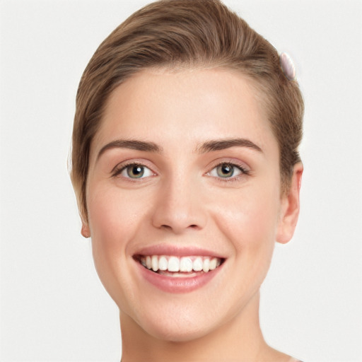 Joyful white young-adult female with short  brown hair and grey eyes