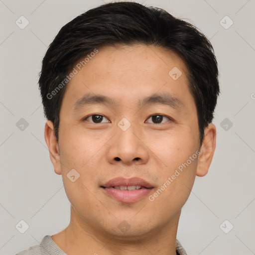 Joyful asian young-adult male with short  brown hair and brown eyes