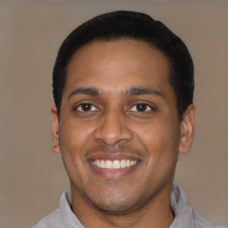 Joyful latino young-adult male with short  black hair and brown eyes