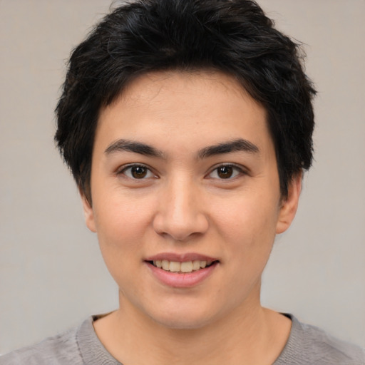 Joyful asian young-adult female with short  black hair and brown eyes