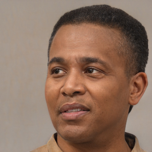 Joyful latino adult male with short  brown hair and brown eyes