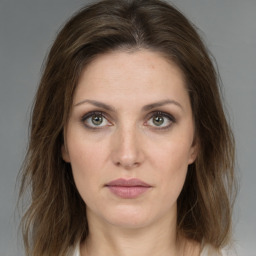 Joyful white young-adult female with medium  brown hair and green eyes